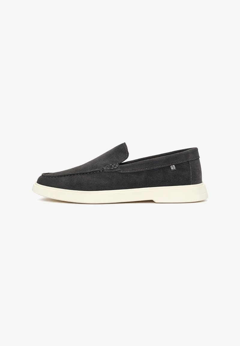 Dark gray suede slip-on shoes with a rounded toe, white sole, and minimal stitching detail along the vamp and sides. No visible branding.