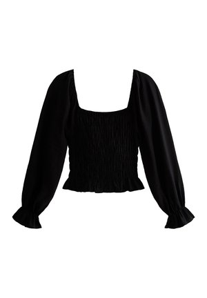 Svart blus med långa, puffiga ärmar och fyrkantig halsringning. Har strukturerad smockning i midjan och volangärmar. Slät tyg.