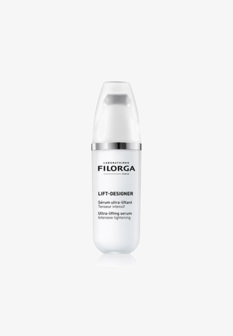 White cylindrical bottle with a curved design, silver accent band, and pump dispenser. Label features black text on a white background.