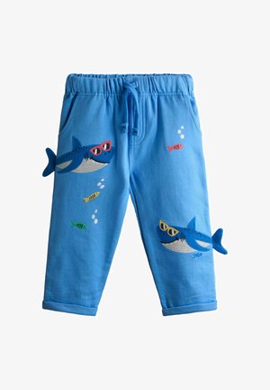 Sinised laste püksid elastse vöökohaga, millel on kaks haide kujutist päikeseprillidega ja väikesed värvilised kalad mullidega.