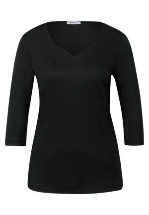 Haut noir à manches longues avec un décolleté en V, fabriqué dans un tissu doux, présentant une texture lisse et une silhouette ajustée. Sans motifs ni ornements.