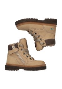 Botines de cuero marrón claro con un forro de piel sintética beige, detalles en marrón, ojales de metal y cremallera lateral. Suela de goma resistente para mejor tracción.