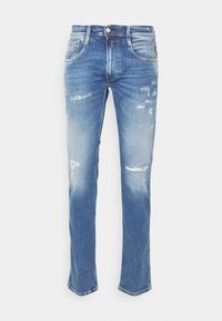 Light blue denim jeans with a regular fit, featuring distressed patches and fading. Classic five-pocket design with a button closure.