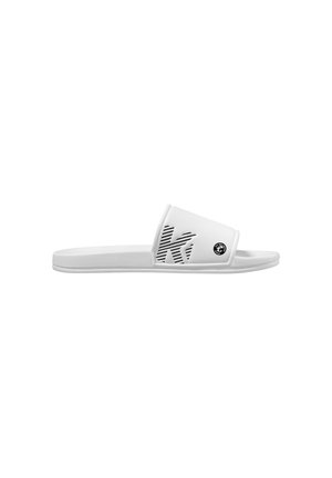 White slide sandal with textured strap featuring a large "K" design and small circular logo on the side, flat sole.