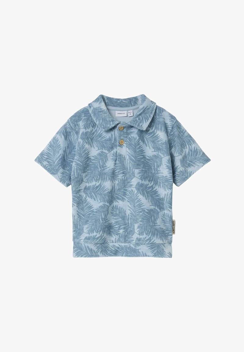 Heledu sinine polo särk, millel on palmilehtede muster, lühikeste varrukatega ja kraega, kaunistatud kahe nupuga. Pehme kangatextuur.