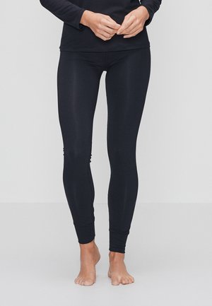 Sorte leggings lavet af et glat, strækbart materiale, med en tætsiddende design og ankelmanchetter, uden synlige mønstre eller metaldele.