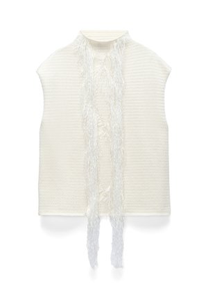 Top bianco senza maniche in maglia con collo alto e lunghe frange pendenti al centro davanti.