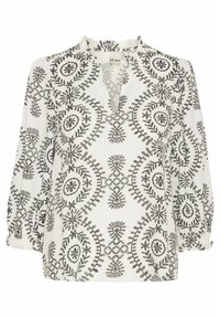 Hvid bluse med sort blomsterbroderi, der har rynket halsudskæring, lange ærmer og en afslappet pasform. Bemærkelsesværdige cirkulære mønstre gennem hele blusen.