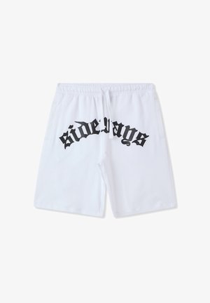 Białe szorty z elastycznym paskiem w talii, z bocznymi kieszeniami i dużą czarną grafiką "bokiem" nadrukowaną z tyłu.