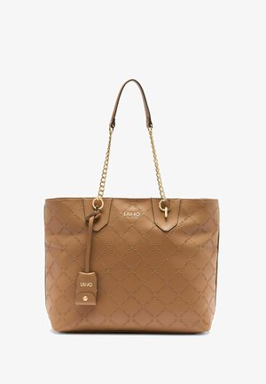 Pruun tekstuuri tote kott kuldsete ahelate aktsentidega, mille keskel on logo ja nahkserv. Ristkülikuline kuju, kahekordsed sangad.