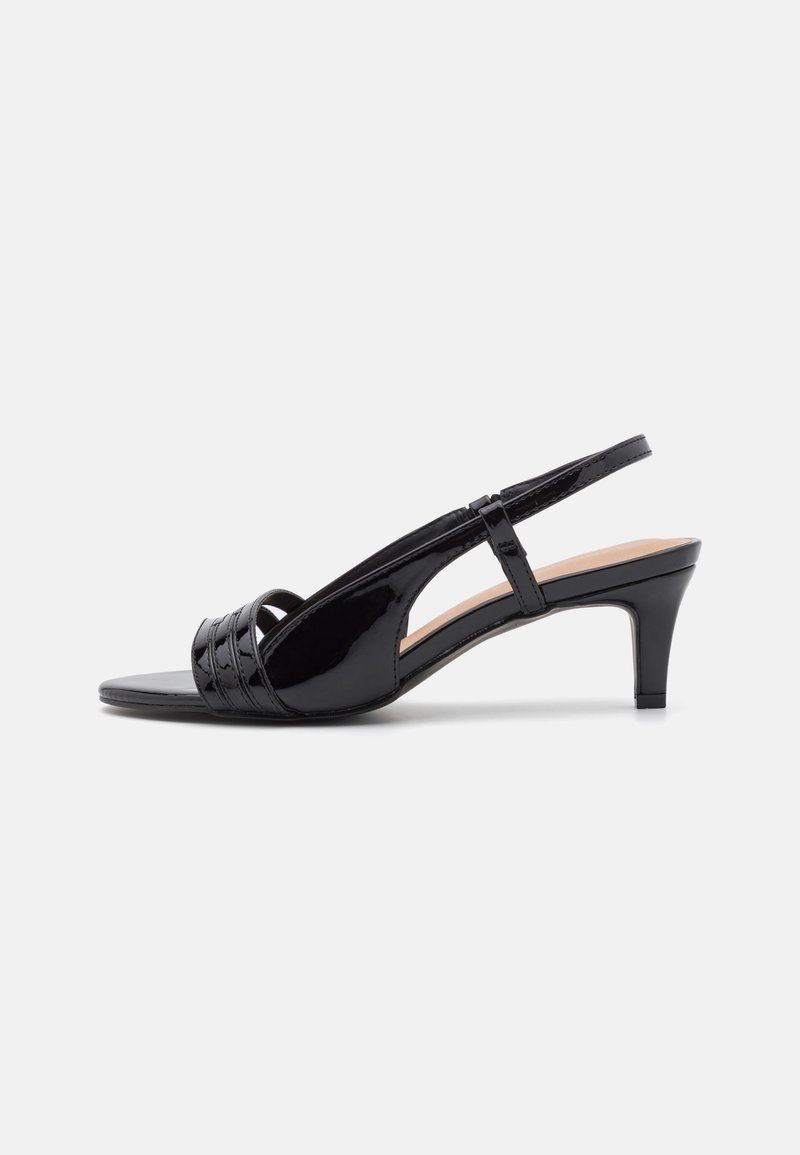 Must musträkk nahast slingback kontsaga kingad suletud varbaga, mis on varustatud väikese laotud kontsaga ja risti rihmade detailiga peal.