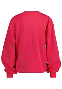 Czerwona, oversize'owa bluza, wykonana z miękkiego materiału, cechująca się okrągłym dekoltem, opadającymi ramionami oraz długimi rękawami z elastycznymi mankietami.