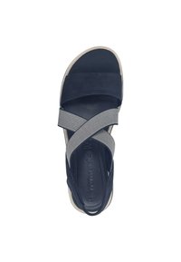 Navy blue sandal featuring cross-straps of textured fabric and smooth material, with a cushioned footbed and light-colored rubber sole.