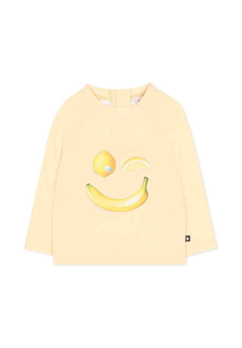 Jasnożółta koszula z długim rękawem z uśmiechającą się twarzą składającą się z cytryny, plasterka cytryny i banana na przodzie.