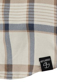Tessuto a scacchi in crema, marrone e navy, con una texture intrecciata. Inclusa un'etichetta nera con il marchio "KEY LARGO".