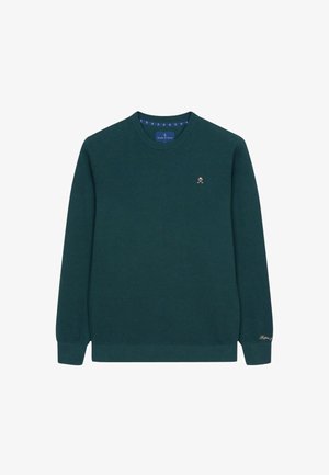Maglione lavorato a maglia verde scuro con collo rotondo, maniche lunghe e polsini a coste. Presenta un piccolo logo dorato sul petto.