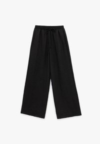 Zwarte wijde broek van textuurstof, met een elastische tailleband en een trekkoord, en een relaxte pasvorm.