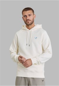 Cremefarbener Hoodie mit Kängurutasche, verstellbarer Kapuze mit Kordelzug und kleinem blauem Logo auf der Brust. Baumwollmischgewebe mit gerippten Bündchen.