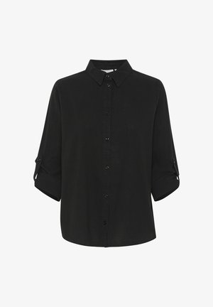 Camisa negra de manga larga con botones, con cuello y mangas enrolladas aseguradas por pestañas con botones, mostrada sobre un fondo liso.