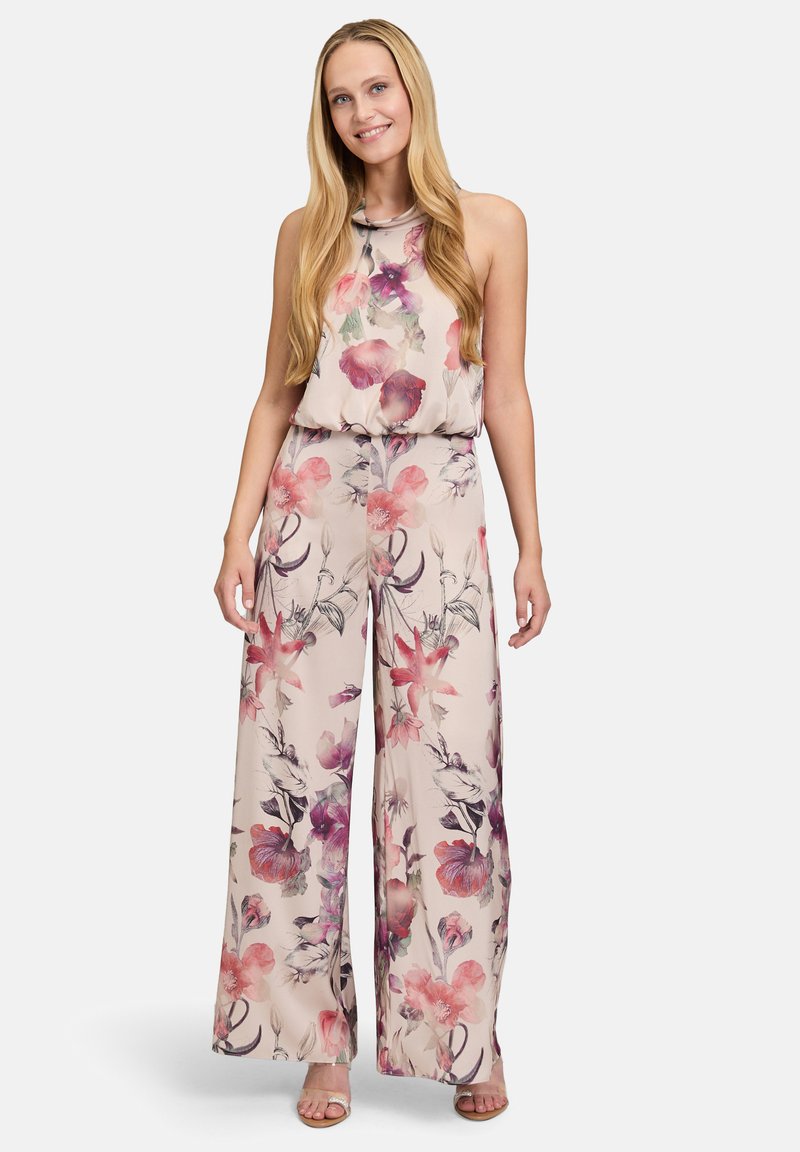 Bloemenpatroon jumpsuit in lichtbeige met roze en paarse accenten. Heeft een losse pasvorm, mouwloos ontwerp en wijde broekspijpen.