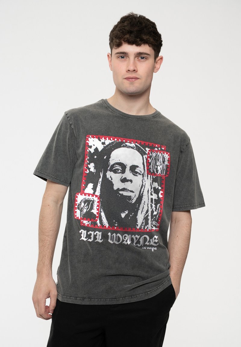 Gray cotton t-shirt featuring a black-and-white graphic of a person framed in red, with text "LIL WAYNE" printed in black at the bottom.