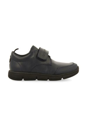 Zapato de piel azul marino con un acabado suave, correa de Velcro, punta redondeada y suela de goma negra acolchada, con detalles de costura sutiles.