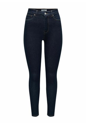 Jeans skinny bleu foncé en denim, avec une fermeture à bouton à l'avant, cinq poches et des accents de couture sur les poches et les coutures.