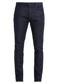 Tmavě modré džíny z denimu, úzký střih s pěti kapsami, zapínání na knoflík a zip, s jemnými texturami a detaily švů.