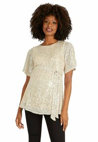Beige Maternity-Top mit Pailletten, kurzen puffärmel und einer Bindung in der Taille, mit einem lässigen Schnitt und einem weichen Stoff.