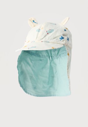 Vaiko baltas saulės skrybėlė su mėlynais ir geltonais oro balionų bei lėktuvo piešiniais, ausis primenančios audinio detalės ir šviesiai mėlyna kaklo apsauga.