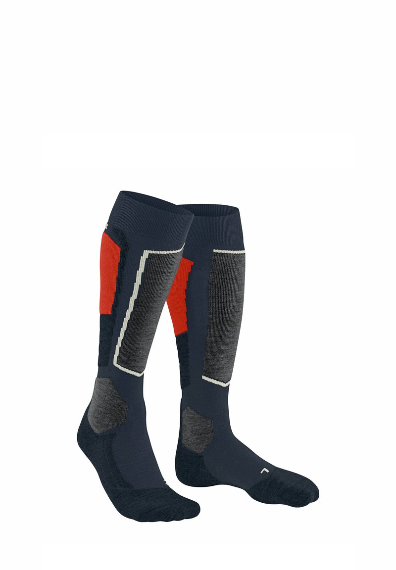 Calzini alti fino al ginocchio di colore blu navy con motivi geometrici rossi e grigi, con cima a costine e rinforzo per la punta e il tallone per una maggiore durata.