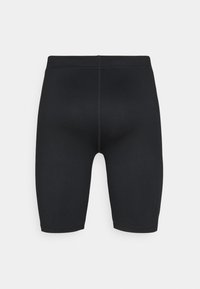Svarta åtsittande cykelshorts med en slät yta och hög midja. Har minimala sömdetaljer och är i medellångt längd upp till låret.
