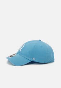 Light blue baseball cap with a white embroidered logo on the front, curved brim, and vent holes; features a small '47' logo on the side.