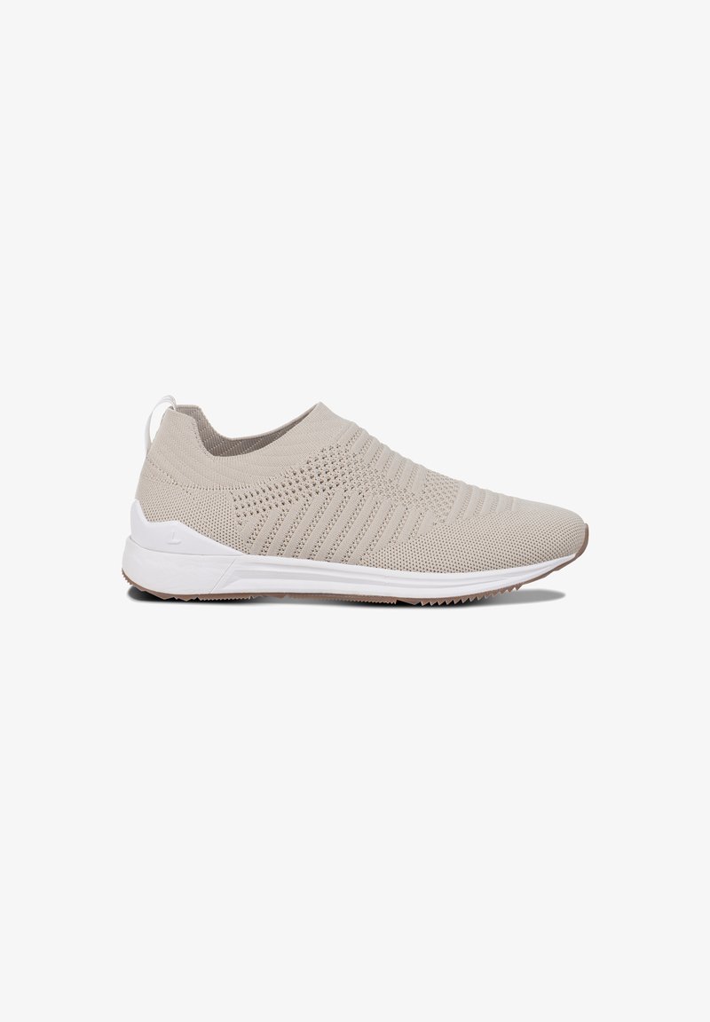 Jasno beżowe sneakersy slip-on z teksturowanym, dzianinowym cholewką oraz białą gumową podeszwą. Posiadają delikatny wzór na cholewce i pętelkę przy pięcie.