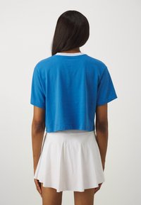 Nike Performance HERITAGE CROP TEE - Spordi T-särk - star blue