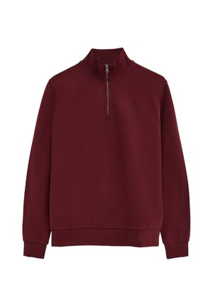 Jersey de manga larga color granate con cuello con cremallera hasta un cuarto y pequeño logo bordado en el pecho izquierdo.