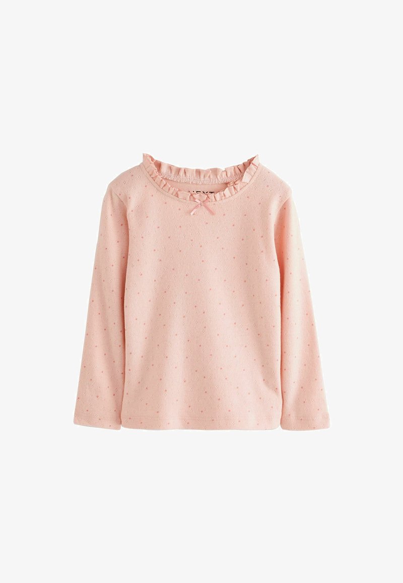 Helltauzes Langarmshirt mit einem rüschierten Ausschnitt und einem Schleifenakzent, das durch das gesamte Gewebe mit strukturierten Punkten versehen ist. Weiches Baumwollmaterial.