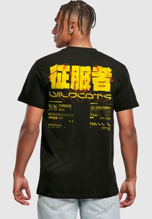 Black cotton t-shirt featuring a large yellow graphic print on the back, incorporating text and abstract designs with caution symbols.