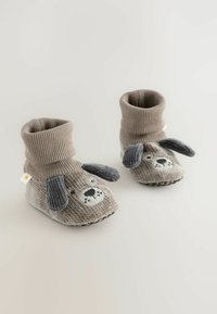 Graue gestrickte Booties, die wie ein Hund gestaltet sind, mit gestickten Gesichtszügen, grauen, schlaffen Ohren und einem gerippten Knöchelbund.