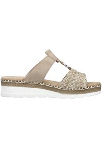 Sandale à glissière beige avec des détails tissés et une tige texturée. Semelle épaisse blanche avec un accent tissé naturel et des coutures décoratives.