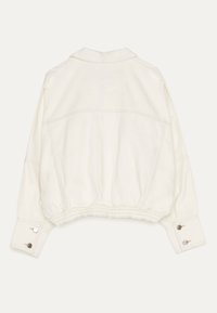 Off-white cropped jacket with wide cuffs, snap button details, and elasticated waistband, shown from the back on a plain background.