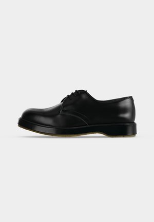 Black leather lace-up dress shoe with smooth finish and thick sole, shown in side profile on a plain white background.