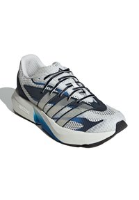 Bijela i mornarsko plava mrežasta tenisica za trčanje s crnim i sivim prugama, crnim vezicama i debelim bijelim đonom s plavim detaljima.