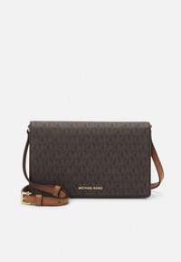 Brown leather crossbody bag with a tan strap. Features a monogram pattern with gold hardware. Compact rectangular shape. Gold logo on front.