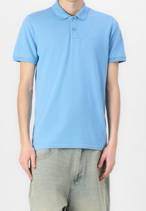 Lichtblauw poloshirt van katoen, met een knoopsluiting met twee knopen, korte mouwen en een subtiel geborduurd logo op de borst.