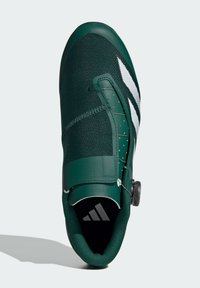 Green cycling shoe with textured fabric and synthetic leather accents. Features a secure closure system and white stripe logo detail.