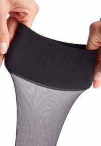 Schwarze blickdichte Strumpfhosen mit einem breiten gestrickten Bund, auf dem der eingeprägte Markenname "FALKE" zu sehen ist. Das Material ist glatt und semi-transparent.