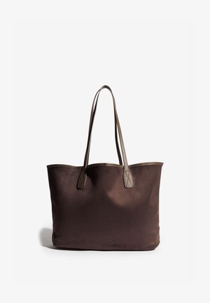 Braune Stofftragetasche mit glatter Textur, langen Ledergriffen und minimalistischem Design. Mit kontrastierendem Lederbesatz.