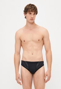 Speedo neri con un design elegante e pannelli testurizzati sui lati. Materiale leggero con vita elastica per il massimo comfort.