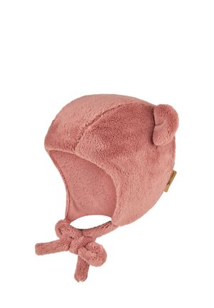 Pink fleece hat with bear ears, knot ties, and soft texture. Features rounded shape and a tag on one side for brand identification.
